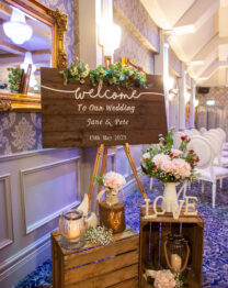Elegant wedding welcome sign in cosy Anner Hotel setting.