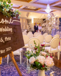 Elegant wedding setup at The Anner Hotel with floral decor and welcoming sign.