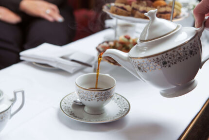 Elegant afternoon tea at Anner Hotel with guests enjoying tea and pastries.