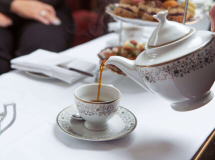 Elegant afternoon tea at Anner Hotel with guests enjoying tea and pastries.