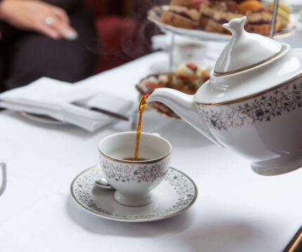 Elegant afternoon tea at Anner Hotel with guests enjoying tea and pastries.