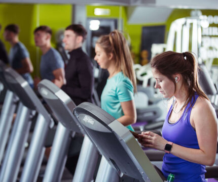 Guests enjoying a workout session in the modern gym at The Anner Hotel.
