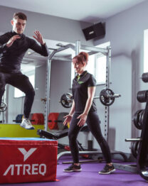 A person exercises with a trainer in a gym at The Anner Hotel's leisure centre.