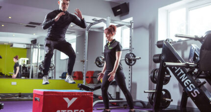 A person exercises with a trainer in a gym at The Anner Hotel's leisure centre.