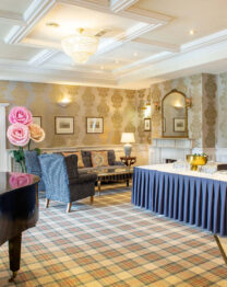 Elegant hotel lounge with seating and refreshments ready for guests.