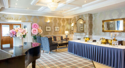 Elegant hotel lounge with seating and refreshments ready for guests.