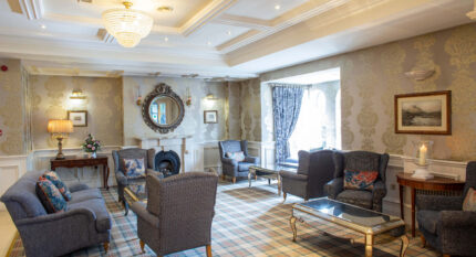 Elegant lounge with cosy seating at The Anner Hotel, perfect for gatherings.