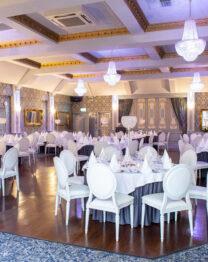 Elegant banquet hall with round tables set for an event at The Anner Hotel.