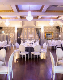 Elegant dining area with chandeliers, set for a family gathering or event at The Anner Hotel.