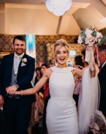 A joyful couple celebrating their wedding reception at The Anner Hotel, surrounded by loved ones.