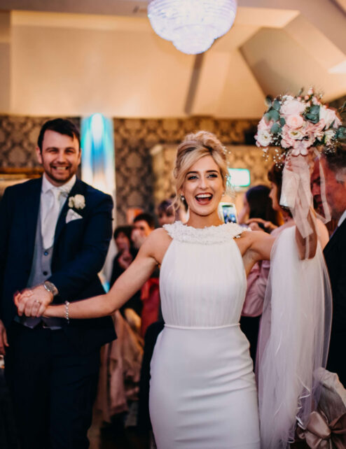 A joyful couple celebrating their wedding reception at The Anner Hotel, surrounded by loved ones.