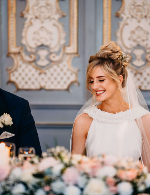 A joyful couple at a wedding reception in a beautifully decorated ballroom at The Anner Hotel.