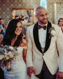 A smiling couple celebrates their wedding with guests at The Anner Hotel.