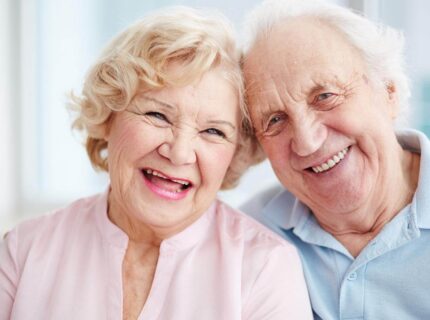 Elderly couple smiling warmly at The Anner Hotel, embracing serenity and joy.