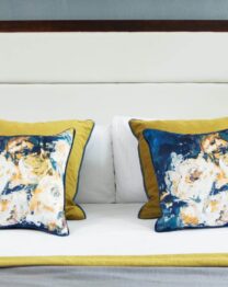 Elegant hotel room with floral pillows and fresh orchids enhancing a welcoming atmosphere.